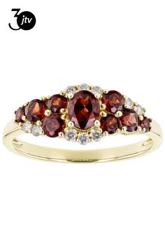 a yellow gold ring with three red and white stones on the band, set in 18k