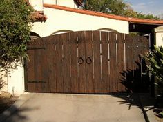 a wooden gate in front of a house