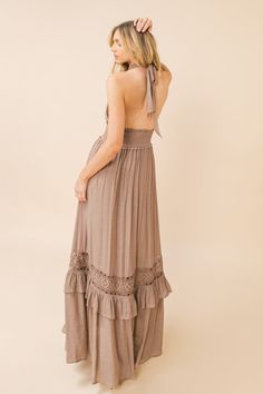 A solid woven maxi dress featuring halter neckline, smocked waist band and lace inset with ruffled hemline Details Self: 65% Polyester, 35% Rayon Contrast: 100% Cotton Lining: 100% Polyester Size & Fit - Model is 5`8" And Wearing Size Small - Measurements Taken From Size Small - Approx. Length: 46" Summer Floor-length Maxi Dress With Smocked Back, Flowy Floor-length Maxi Dress With Lace Trim, Fitted Floor-length Maxi Dress With Smocked Back, Flowy Lace Trim Floor-length Maxi Dress, Beach Floor-length Maxi Dress With Ruffles, Floor-length Ruffled Maxi Dress For Beach, Bohemian Rayon Maxi Dress With Ruffles, Chic Lace Trim Maxi Dress, Beige Floor-length Maxi Dress For Beach