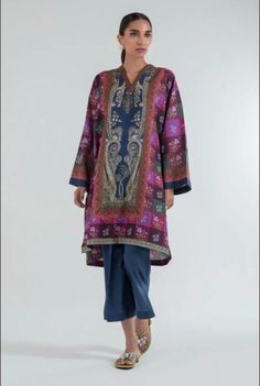 Introducing our stunning and chic two-piece kurta and pants set - a must-have addition to your wardrobe. Made from high-quality fabric, this set is designed for both comfort and style. The kurta features delicate details that add a touch of elegance to your look. The length of the kurta is just right, hitting just above the knees for a modern and sophisticated look.  The pants are designed in a straight leg style, featuring a comfortable and adjustable waistband for a perfect fit. The length is just right to complement the kurta, creating a cohesive and stylish outfit. Whether you're attending a wedding, Eid celebration, or simply want to elevate your everyday look, this set is perfect for any occasion. Pair it with your favorite accessories, shoes, and bag to create a complete look that w Elegant Sets With Printed Motifs For Eid, Semi-stitched Naqshi Palazzo Set With Straight Kurta, Elegant Long Sleeve Cambric Sets, Naqshi Jamawar Straight Kurta Set, Silk Palazzo Set With Naqshi For Eid, Traditional Long Sleeve Pant Set With Zari Work, Bollywood Style Long Sleeve Pant Set For Eid, Unstitched Bollywood Pant Set With Dabka Work, Elegant Cambric Sets With Printed Motifs