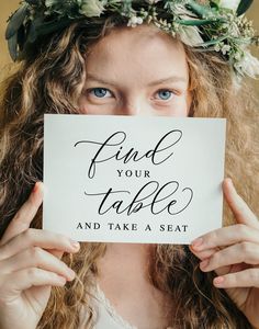 a woman holding up a piece of paper with the words memory table written on it