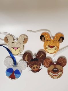 three mickey mouse ears are hanging from a string on a white surface with other decorations