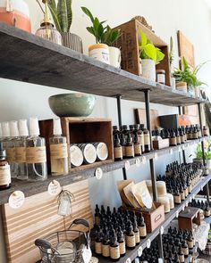 the shelves are filled with many different types of essential oils and bottles on them,