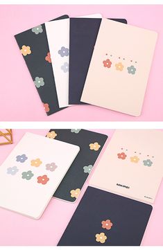 four notebooks with flower designs on them sitting next to each other in front of a pink background