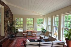 a living room filled with furniture and lots of windows