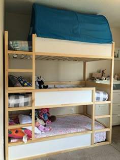 a bunk bed with lots of toys on it