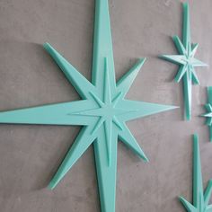 four green star shaped objects are on the floor