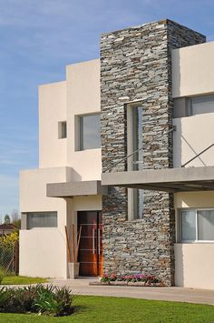 a modern house with stone and stucco exterior