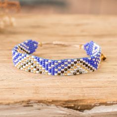 a close up of a bracelet on a wooden surface