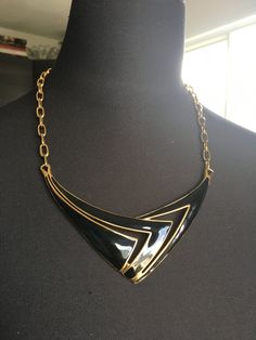 "Beautiful Monet statement necklace. Modernist design in a shiny gold tone and black enamel. CONDITION In excellent vintage condition. No wear, marks or damage. Closures are all secure The necklace measures approximately 20 inches and 1 3/4\" wide. The necklace is signed with © Monet. It is in excellent vintage condition Please see this section of my shop for more vintage costume jewelry: https://www.etsy.com/shop/ChrisandTine?section_id=17309162 My full shop: http://www.chrisandtine.etsy.com Pr Modern Gold Necklace With Black Enamel, Vintage Black Enamel Necklaces For Evening, Vintage Black Enamel Necklace For Evening, Retro Black Metal Necklace, Formal Black Enamel Necklaces, Formal Black Enamel Necklace, Vintage Black Enamel Jewelry, Black Vintage Enamel Jewelry, Vintage Black Enamel Necklaces For Formal Occasions