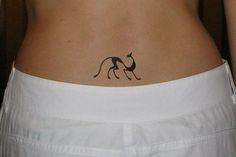 a woman with a tattoo on her lower back is standing in front of the camera