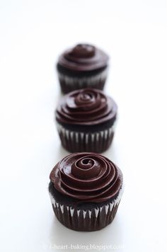 three chocolate cupcakes sitting on top of each other