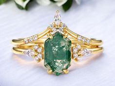 Discover the beauty of our UNIQUE MOSS AGATE RING, featuring an elegant gold leaf design that gracefully frames the natural charm of moss agate. Perfect for engagements, anniversaries, or birthdays, this exquisite two-piece stacking ring set offers both versatility and style. It works perfectly as an engagement and wedding ring! **Key Features - **Material High-quality moss agate and durable gold plating - **Design Unique gold leaf accents enhancing the natural stone - **Occasion Ideal for Christmas, Mother's Day,  engagement, anniversaries, and birthday gifts Green moss, sterling silver, ab band, white zircon, measures 5*8, silver weight 2.7 grams. Each ring is crafted sustainably, ensuring a responsible choice for the eco-conscious buyer.  Receive a FREE Personalized Infinity Brooch with Gold Wedding Ring Sets, Agate Rings, Soft Cut, Gold Leaf Design, Agate Engagement Ring, Moss Agate Ring, Breathtaking Beauty, Gold Ring Sets, Agate Ring