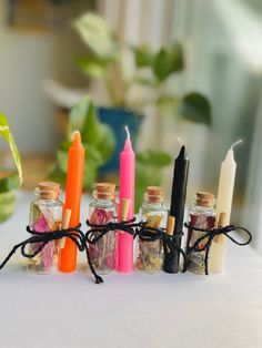 there are many small bottles with candles in them