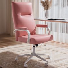 a pink office chair sitting on top of a wooden floor