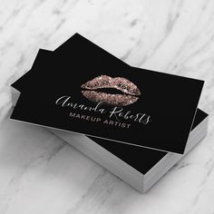 two business cards with gold glitter lips on black and white marble background, one is for makeup artist