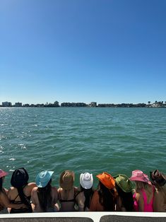 several people sitting on a boat looking out at the water