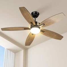 a ceiling fan with wooden blades in a room