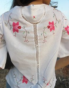 Tie front blouse in white with hand embroidered floral details and crochet panels. V neckline. Short sleeve. Ties to front. Size M, EU 38-42 / UK 10-14. Measurements: 40"/ 102cm bust - 12" / 30cm sleeve length - 25" / 64cm blouse length. Condition - New. Material - Cotton. Sustainability - Remade by our in house team using vintage fabrics. Model is a UK 6/8 & 5'7" tall. Crochet Panels, Embroidered Blouses, Jumpsuit Skirt, Tie Front Blouse, Sleeveless Jacket, Something Different, Vintage Fabrics, Blouse Length, Beach Wears