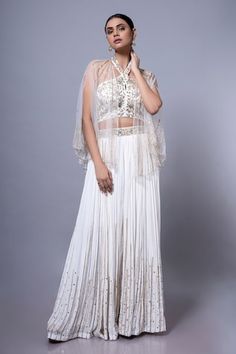 White padded blouse featuring floral hand embroidery all over. Paired with an embroidered palazzo and a sheer cape. - Aza Fashions Traditional Drape Embroidered Top For Wedding, Wedding Top With Intricate Embroidery On Georgette, Sleeveless Blouse With Dupatta For Wedding, White Tops With Dupatta For Festive Occasions, Elegant Sleeveless Blouse With Dupatta, Sleeveless Resham Embroidered Fabric For Wedding, Sleeveless Blouse With Dupatta For Reception, Sleeveless Embroidered Fabric For Wedding, Sleeveless Wedding Fabric With Resham Embroidery