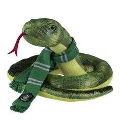 a stuffed snake wearing a green scarf and holding a red object in it's mouth