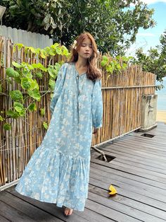 Introducing our Lola Bohemian Cotton Maxi Dress in Blue Limited Edition - an exceptionally unique piece available in limited quantities. The Lola's captivating design is meticulously handcrafted using wooden blocks meticulously placed on the finest cotton voile, resulting in a dreamy block printed pattern that draws inspiration from the bougainvillea flower and the essence of vacation. This dress exudes timeless femininity, boasting a maxi-length with an oversized style, making it a versatile ch Light Blue Cotton Bohemian Dress, Bohemian Light Blue Cotton Maxi Dress, Blue Cotton Boho Maxi Dress, Blue Cotton Boho Dress For Vacation, Blue Floral Print Cotton Boho Dress, Blue Cotton Boho Dress With Floral Print, Blue Floral Cotton Boho Dress, Blue Cotton Boho Dress With Block Print, Bougainvillea Flower