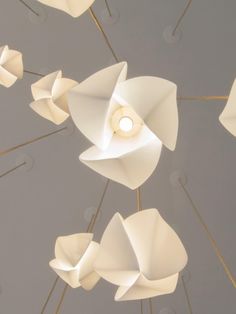 the ceiling light is designed to look like paper flowers and petals, with one bulb at the center