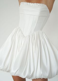 the back of a woman's white dress