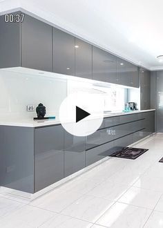 a large kitchen with white floors and gray cabinets