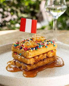 a plate with some food on it and a flag sticking out of the top one