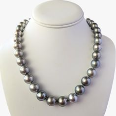 Experience the timeless elegance, crafted with exceptional quality and beauty. The necklace features lustrous Tahitian pearls of various sizes, ranging from 11 to 15 mm, and is finished with an 18K Rhodium-plated white gold and diamond clasp that adds a touch of luxury to the piece. The clasp contains 56 round brilliant cut diamonds (NC/SI) with a total weight of 1.23ct. The pearls showcase a silvery gray color pearls that exudes sophistication and refinement, with a uniformity that creates a harmonious appearance. Each pearl is carefully selected for its exceptional quality and luster, with a high shine and round shape that enhance the necklace's overall elegance. The necklace's length of 19 inches makes it versatile, pairing effortlessly with most necklines, and the weight of 99 grams pr Pearl Clasp, Tahitian Pearl Necklace, A Ha, Tahitian Pearls, Small Jewelry, Pearl Size, Round Brilliant Cut Diamond, Cultured Pearls, Brilliant Cut Diamond