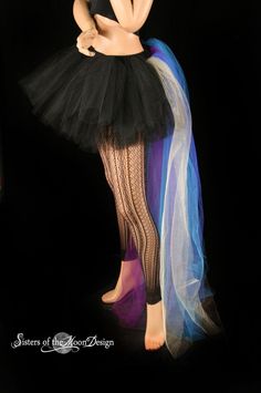 "Handmade from 25yards, two layers of soft smooth Black Bridal tulle, that has been gathered and serged to the black fabric covered elastic waistband, the back bustle(attached) is made from two layers of long bridal tulle in gold, royal, turquoise, purple, teal. It is around 50\" long and will trail behind you! This skirt is not made yet, It is made when ordered! Measurement: Sizes go by (in inches) smallest waist size tutu will fit, to largest Hips tutu fits over XSmall 24\"-34\" Small 26\"-38\ Halloween Costume Petticoat With Attached Cancan, Halloween Costume Petticoat With Cancan, Halloween Stretch Tulle Petticoat, Stretch Tulle Petticoat For Halloween, Fitted Petticoat For Halloween Costume Party, Stretch Petticoat For Halloween Costumes, Halloween Fitted Tulle Petticoat, Gothic Black Petticoat For Halloween, Black Gothic Petticoat For Halloween