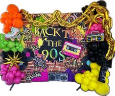 a party backdrop with balloons, streamers and boomboxes in the shape of a brick wall