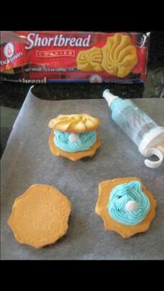 some cookies are sitting on a cookie sheet with icing next to the doughnuts