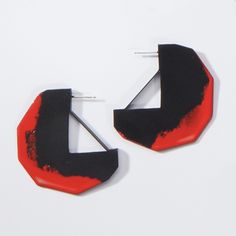 Edge Hoop Earrings by Eliana Arenas. The hoop is reimagined with the artistry of a geometric brass shape and a pairing of powder-coated finishes. Sterling silver posts. 2L, 2W. Bold Geometric Designed Earrings, Bold Geometric Earrings With Bold Design, Bold Geometric Earrings, Modern Red Hoop Earrings, Modern Small Red Hoop Earrings, Contemporary Single Hoop Earring, Modern Red Small Hoop Earrings, Modern Geometric Single Hoop Earring, Modern Handmade Hoop Earrings