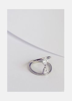 a white gold ring with two pear shaped diamonds