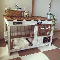 a dog is sitting in his cage on the floor