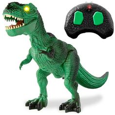 a toy dinosaur with its mouth open next to a controller