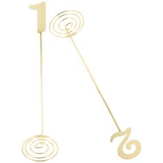 a pair of gold metal stirs with numbers on each side and one in the middle