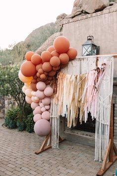 a bunch of balloons that are hanging on a wall