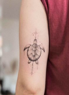 a small turtle tattoo on the arm