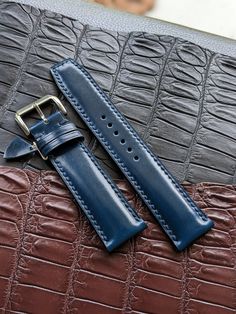 "This blue watch strap is made from the premium and highly sought-after Shell Cordovan leather. Known for its durability, strength, and unique shine, Shell Cordovan leather is the ultimate choice for a high-quality leather strap. The natural oils in the leather give it a distinctive luster that will only improve with age. The hand-stitching adds to its classic aesthetic, while the sturdy construction ensures that it will last for years to come. Whether you're looking for a timeless accessory or simply want a durable and stylish watch strap, this handmade Shell Cordovan option is the perfect choice. Details :  Topside: Shell Cordovan Luxury Leather All of our Handmade Leather Watch Strap and other product are fully personalizable, please just let me know what would you like to personalize / Classic Blue Rectangular Watch Accessories, Blue Rectangular Business Watches, Classic Blue Watches With Stainless Steel Clasp, Elegant Blue Rectangular Watch Accessories, Classic Business Watch Bands With Bracelet Strap, Classic Business Watch Band With Bracelet Strap, Formal Rectangular Leather Strap Watch Bands, Formal Adjustable Leather Strap Watch Bands, Classic Watch Strap As Gift