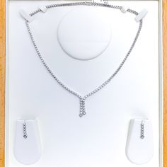 Elevate your style with this Graceful Diamond Tassel Necklace Set. Crafted with 18k white gold and 2.94ct diamonds in round shape, this set has a set length of 17" and a drop length of 1". It features a push lock with clasp and comes with matching earrings. The necklace has a weight of 30.8g, making it a perfect addition to your high fashion wardrobe. PRODUCT DETAILS Gold Purity(karat): 18k Item Weight(grams): 30.8 Item Finish: White Gold Stone: Diamond Diamond Weight(carats): 2.94ct Diamond Col White Gold Diamond Jewelry Sets For Evening, Elegant Dangle Diamond Necklace For Formal Occasions, Elegant Formal Diamond Dangle Necklace, Elegant Formal Dangle Diamond Necklace, Formal White Gold Rhinestone Necklace, Silver Dangle Diamond Necklace For Formal Occasions, White Gold Necklace, 18k Gold Necklace, Lock Style