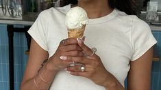 a woman holding an ice cream cone in her hands