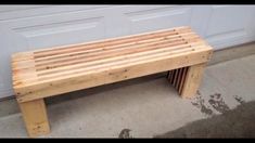 a wooden bench sitting in front of a garage door