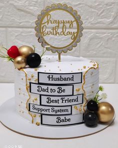 a birthday cake with gold and black decorations on the top is decorated with a happy birthday sign