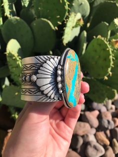 Sterling silver and turquoise. Gorgeous silverwork. Intricate hand-stamped detail. 2 1/2" wide at widest point. Cuff is 1 5/8" wide. Cuff measure 5 3/4" with a 1 1/4" gap. Stamped sterling and signed by Navajo artist. Turquoise Stamped Sterling Silver Cuff Bracelet, Silver Western Cuff Bracelet With Patina, Turquoise Stamped Western Cuff Bracelet, Western Turquoise Stamped Cuff Bracelet, Turquoise Stamped Cuff Bracelet Collectible, Turquoise Western Stamped Cuff Bracelet, Western Style Stamped Turquoise Cuff Bracelet, Southwestern Engraved Blue Cuff Bracelet, Artisan Blue Engraved Cuff Bracelet