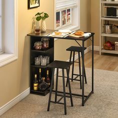 two stools sit in front of a table with food and drinks on it next to a window