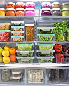 an open refrigerator filled with lots of different types of vegetables and fruits in plastic containers