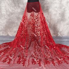 a red wedding veil with flowers on the bottom and sequins at the bottom